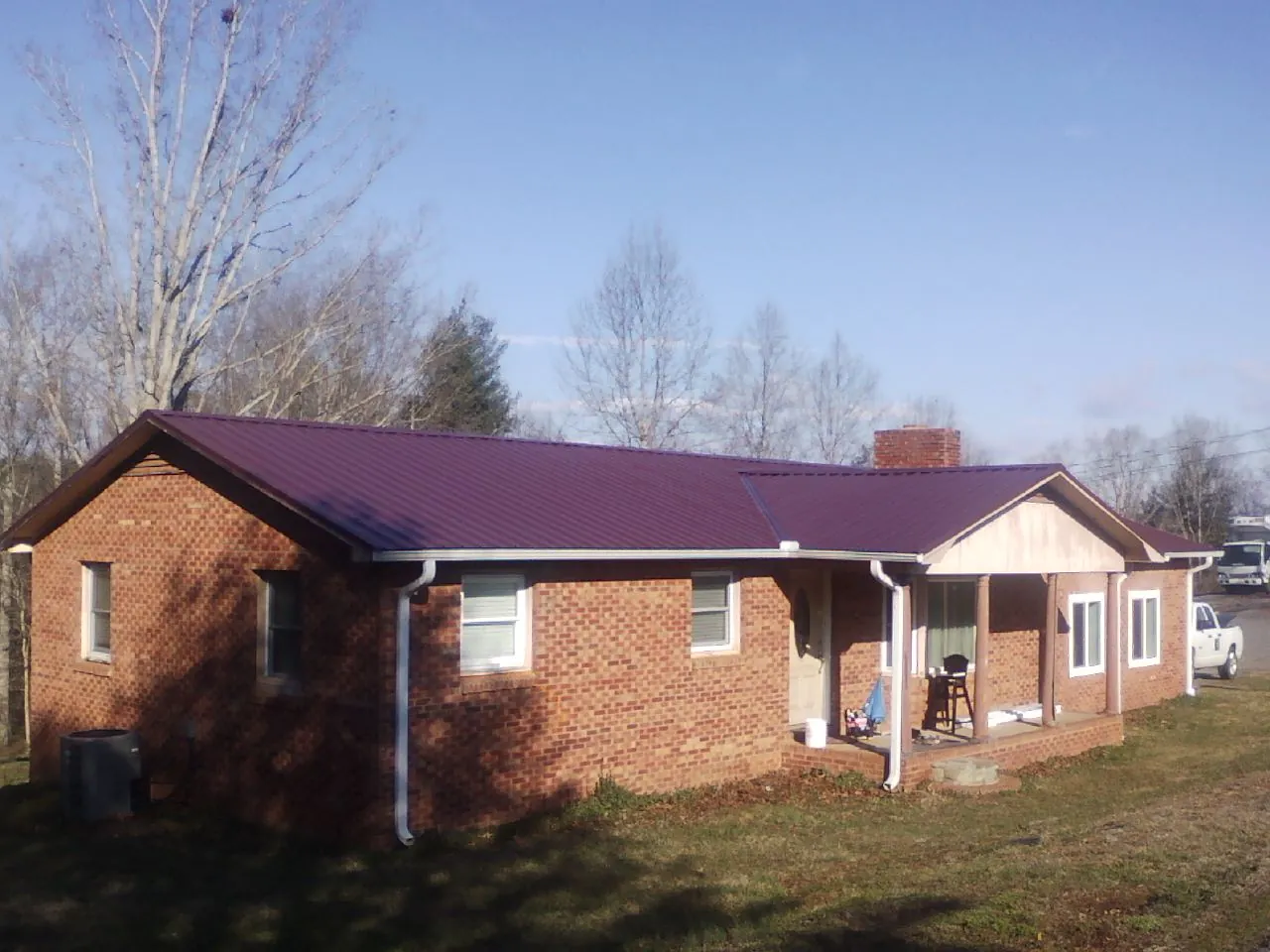Burgundy metal roof on a brick ranch home with a new addition in North Middletown
