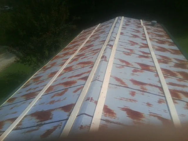 Rusted metal roof panels with new wood purlins before replacement — Storm Damage Roof Repair in North Middletown by Roofing Brothers