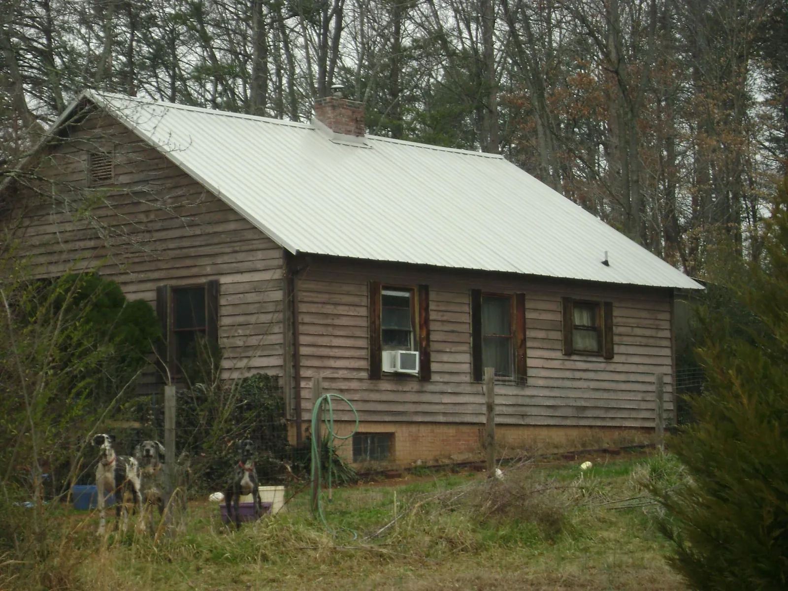 White metal roof on an old wood sided farmhouse, from a Metal Roof Installation job in North Middletown
